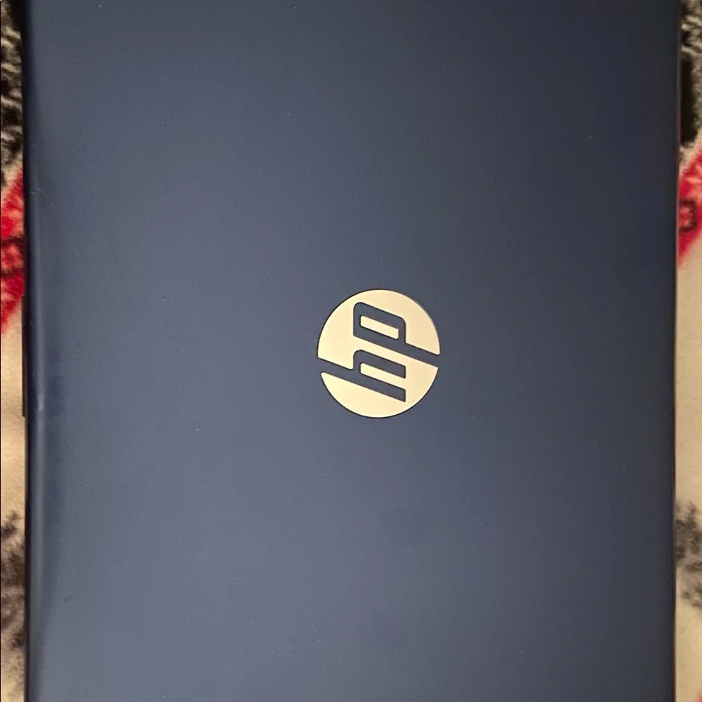HP, navy laptop comes with original charger. It works well no issues at all!